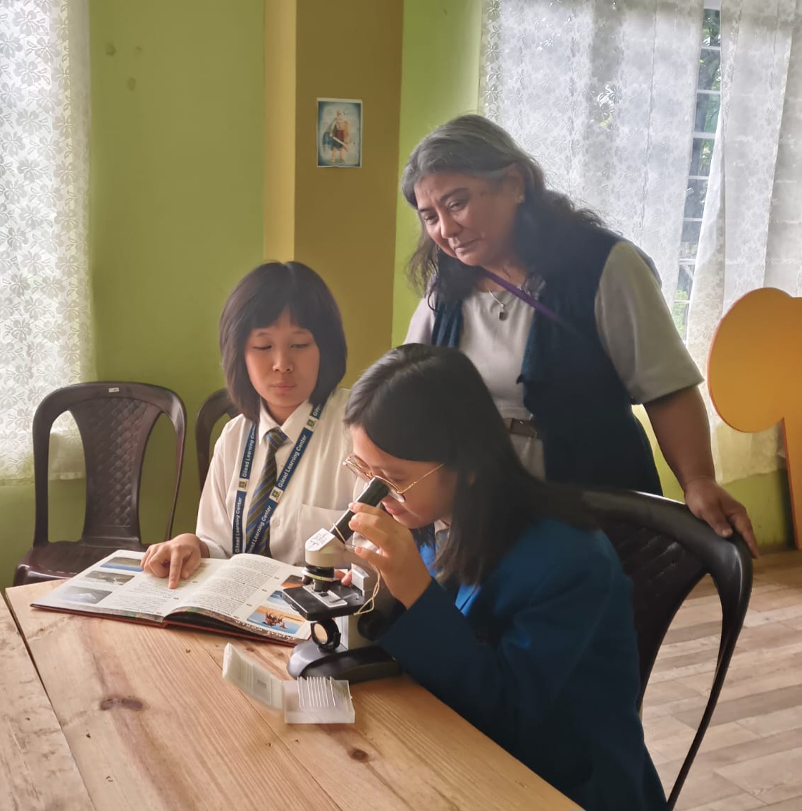 Students exploring science with a microscope in the classroom