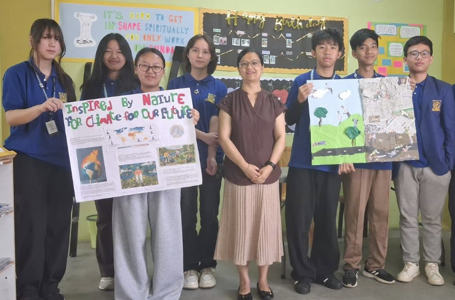 GLC Shillong high school students displaying their class projects with their teacher
